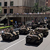 Armoured tanks moving through Brisbane city streets.