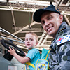 Soldier sitting with a boy on a tank